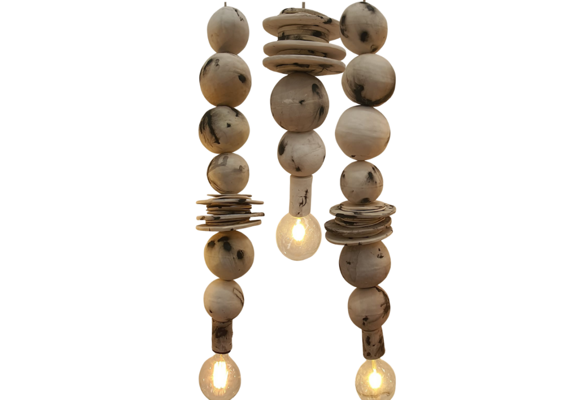A rustic hanging pendant light made from natural clay beads and discs, singular vertical strands