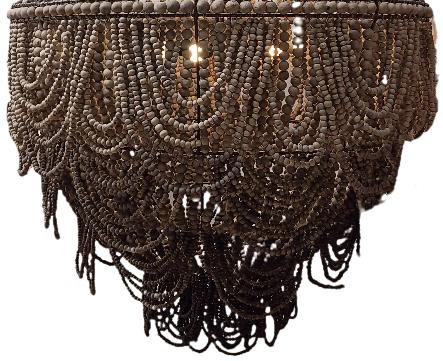 A clay beaded chandelier with multiple tiers of cascading bead strands and hanging fringe.