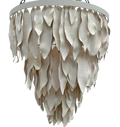 A modern tiered chandelier with overlapping leaf-shaped clay shades 